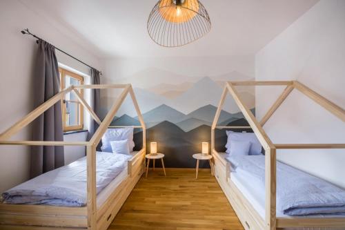 two beds in a room with a mountain mural at Ferienwohnung Maria in Gilching