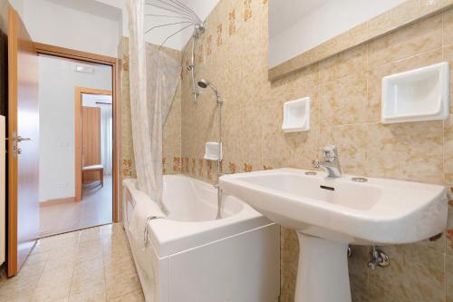a bathroom with a sink and a bath tub at Appartamenti Panelatti in Bono