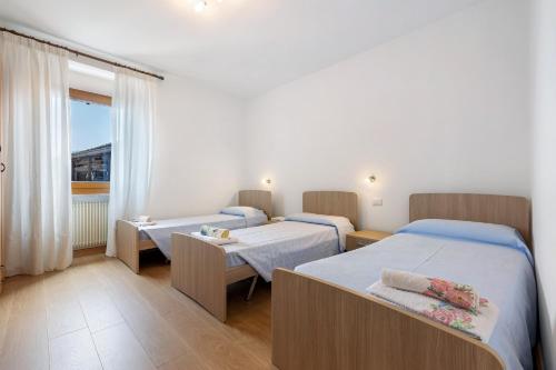 a hospital room with two beds and a window at Appartamenti Panelatti in Bono