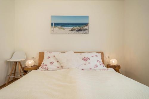 a bedroom with a bed with pink flowers on it at Sunny Appartment in Bregenz