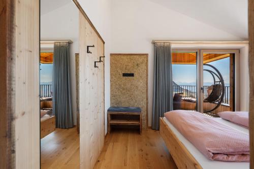 a bedroom with a bed and a window with a view at Moarhof in Meltina