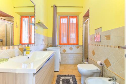 a bathroom with a white sink and a toilet at Appartamenti Marisol in Campo nell'Elba