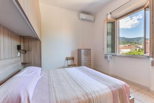 a bedroom with a bed and a window at Appartamenti Marisol in Campo nell'Elba