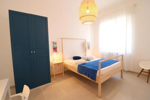 a bedroom with a bed and a blue cabinet at Casa Vacanze Nike a Otranto in Otranto