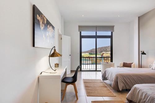 a bedroom with two beds and a desk and a chair at Urban Park Girasol in Los Llanos de Aridane