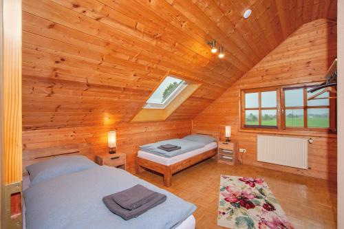 a bedroom with two beds in a wooden cabin at Ferienwohnungen Annamaria in Leutkirch im Allgäu