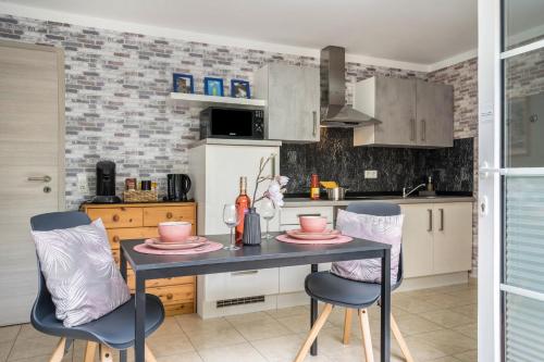 a kitchen with a table and two chairs at Ferienwohnung For two in Mahlberg