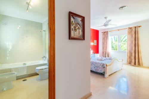 a bedroom with a bed and a bath tub at Villa Cucarres in Calpe