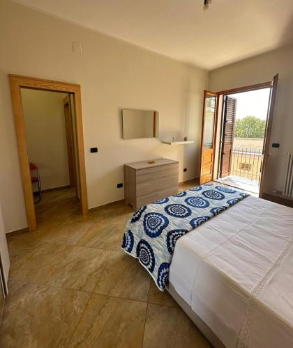 a bedroom with a large bed and a window at Da Katia in Arnesano