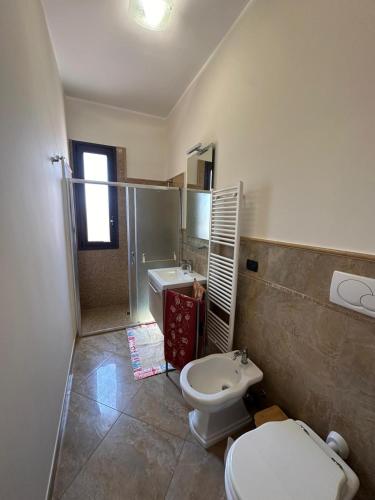 a bathroom with a toilet and a sink at Da Katia in Arnesano
