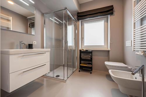 a bathroom with a shower and a toilet and a sink at Plose 35 in Bressanone