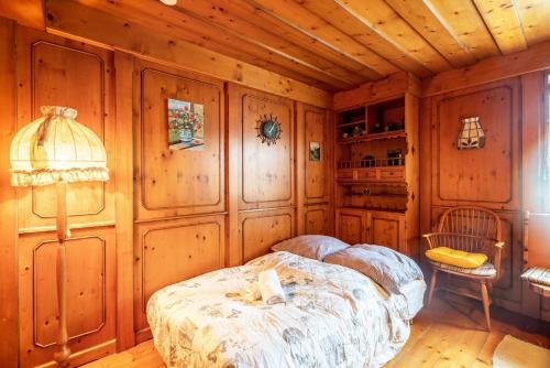 a bedroom with a bed in a room with wooden walls at Munich Hideaway in Karlsfeld