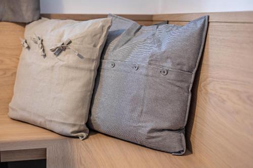 a couple of pillows sitting on a bed at Plose 35 in Bressanone