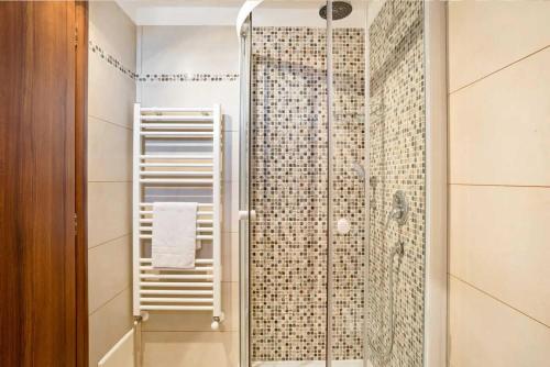 a bathroom with a shower with a glass door at Trullo Mandorlo in Martina Franca