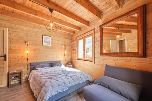 a bedroom with a bed in a wooden cabin at L'auberge du Bati in Besse