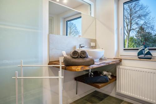 a bathroom with a sink and a mirror at Ferienwohnung Manthei in Kluis