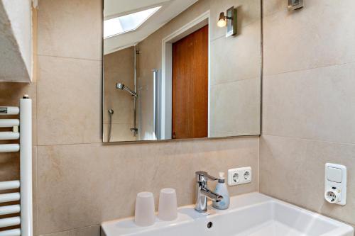 a bathroom with a sink and a mirror at Johannas Alm in Garmisch-Partenkirchen