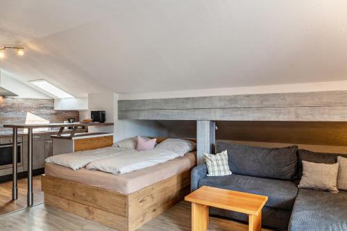 a bedroom with a bed and a couch in a room at Johannas Alm in Garmisch-Partenkirchen
