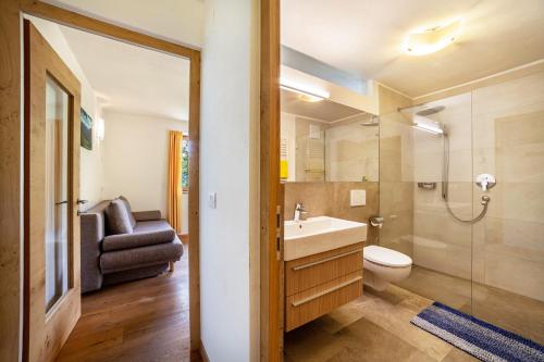 a bathroom with a sink and a toilet and a shower at Fichtenhof Wohnung Enzian in Tarces