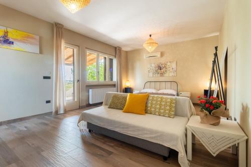 a bedroom with a bed with yellow pillows on it at A Look Salento in Castrignano del Capo