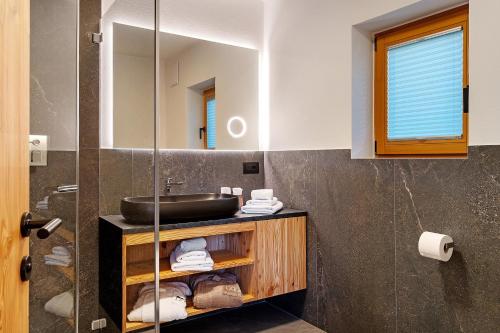 a bathroom with a sink and a mirror at Apt Lara Ruveda 2 in Ortisei