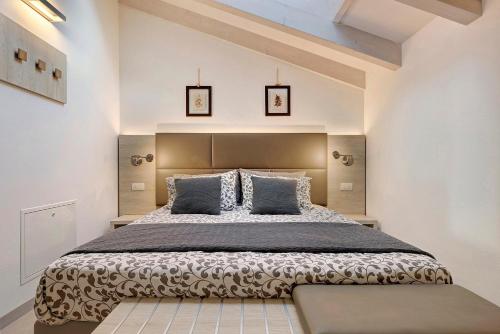 a bedroom with a large bed with two pillows at Eco Del Garda Bnb in Tenno