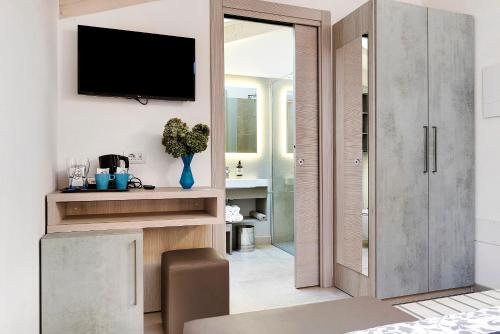 a living room with a tv on a wall at Eco Del Garda Bnb in Tenno