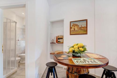 a room with a table with a vase of flowers at G House Dolceacqua in Dolceacqua