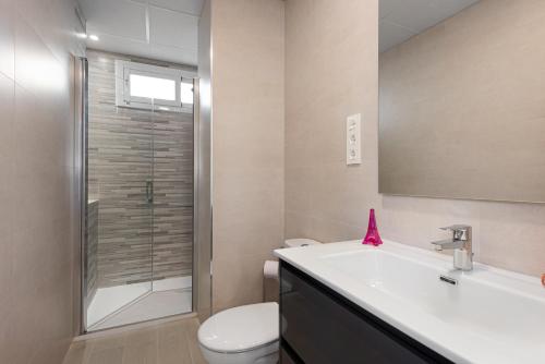 a bathroom with a sink and a toilet and a shower at Apartamentos Sealmar Moliere in Málaga