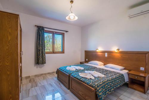 a bedroom with a bed with two towels on it at Mirage Arillas Apartment C in Arillas