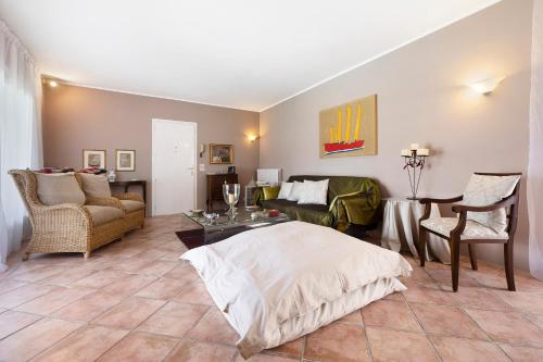 a living room with a bed and a couch at Villa Corneghe with pool in Gargnano