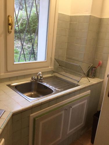 a sink in a kitchen with a window at Villa Corneghe with pool in Gargnano