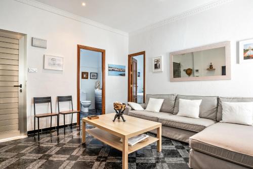 a living room with a couch and a table at Casa Calle Ancha in Barbate
