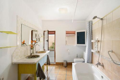 a bathroom with two sinks and a bath tub at Casa Las Flores in Moya