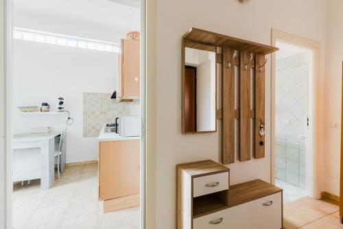 a kitchen with a sink and a mirror in a room at Casa Rimedia in Solanas