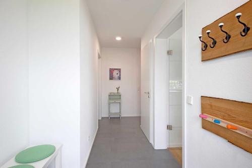 a hallway of a house with white walls and a staircase at Ferienhaus Moos in Wasserburg