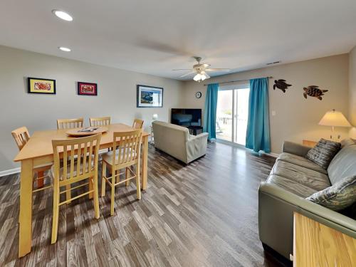a living room with a table and a couch at Lazy Daze in Surf City