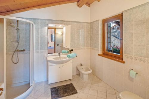 a bathroom with a sink and a shower and a toilet at Il ciliegio sul lago in Verceia