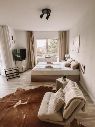 a large bedroom with two beds and a couch at Ferienwohnung am Reißberg in Plauen