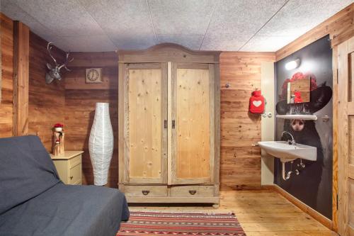 a bedroom with a sink and a wooden wall at Zähringer Hütte in Feldberg