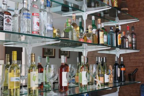 a shelf full of wine bottles and glasses at Boracay Haven Suites in Boracay