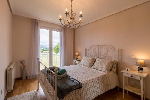 a bedroom with a white bed and a window at El Rincón de Agüero in Agüero
