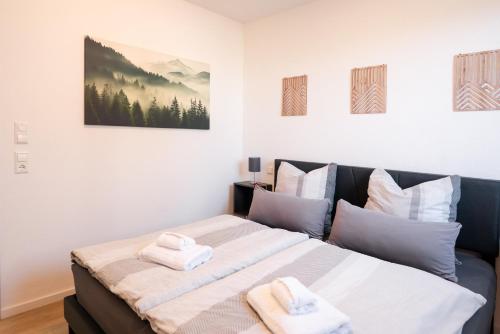 a bedroom with a large bed with towels on it at Corner 28 in Oberkirch