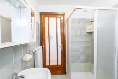 a bathroom with a toilet and a sink and a mirror at Casa Rita app 4 in Tremosine Sul Garda