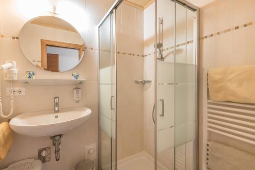 a bathroom with a sink and a shower at Huberhof App Gala in Feldthurns