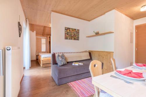 a living room with a couch and a table at Huberhof App Gala in Feldthurns