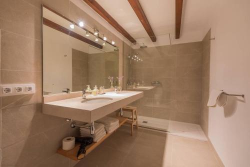 a bathroom with two sinks and a large mirror at Cuixach villa in Pollensa with Wifi in Pollença