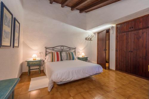 a bedroom with a bed and two tables with lamps at Cuixach villa in Pollensa with Wifi in Pollença