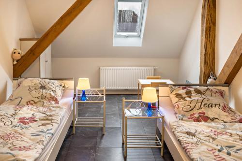 a room with two beds and a table at Fewo-llojan in Wiesmoor