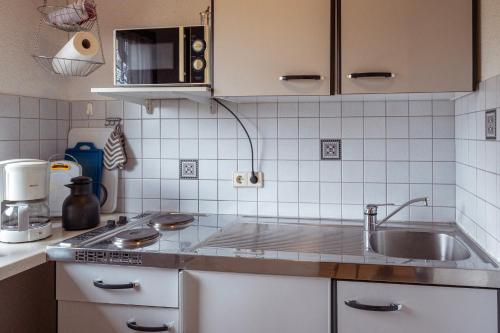 a kitchen with a sink and a counter top at Hinterhauensteinhof in Hornberg